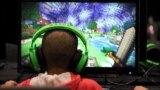 U.K. -- A child plays video game Minecraft at the Minecon convention in London July 4, 2015. The 10,000 tickets sold for Minecon in London made it the largest ever convention for a single video game.